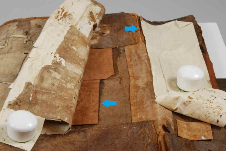 Inside cover, previous modern repair: machine-made paper and leather patches to reinforce the cover. Photo by Deborah Howe, courtesy of Dartmouth College Library.