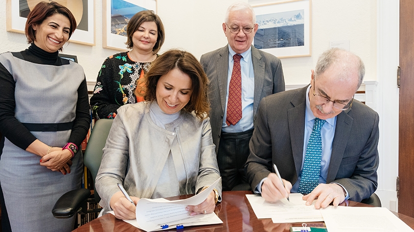 Sheikha Dana Nasser Sabah Al Ahmed Al Sabah, chair of the AUK board of trustees, and President Phil Hanlon ’77 sign a new MOU as, from left, Amal Albinali of AUK; Aseel al-Awadhi of the Kuwaiti Embassy; and Dale Eickelman ’64, look on. (Photo by Eli Burakian ’00)