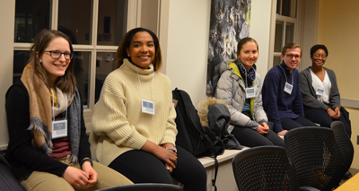 Interns sit in a meeting.