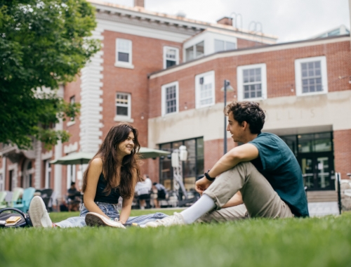 Students sit and chat on the Dartmouth Green.